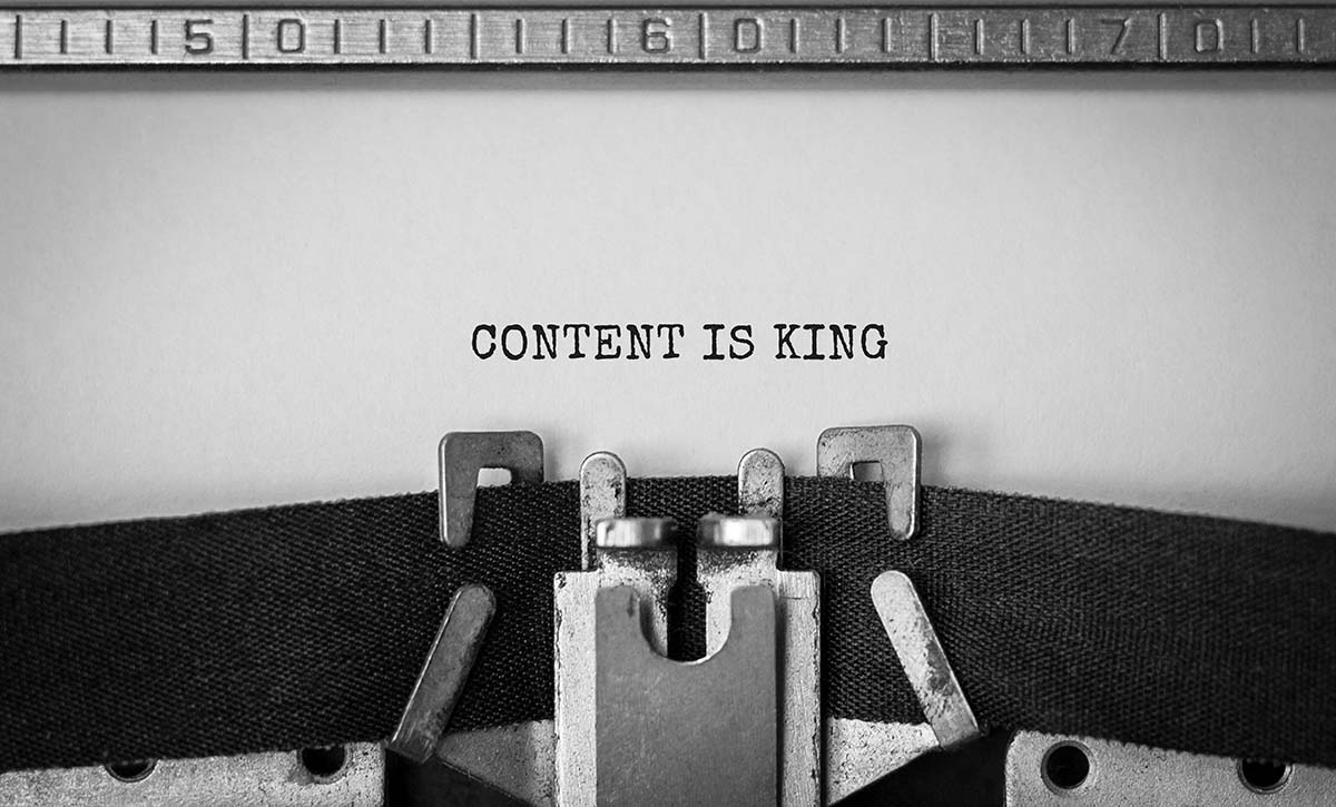 Black and white image of a typewriter with the words "CONTENT IS KING" in all caps